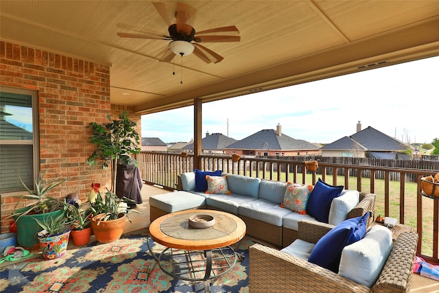 view of patio featuring a ceiling fan, a residential view, fence, and an outdoor hangout area