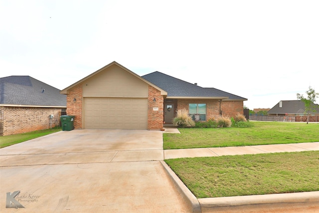 ranch-style home with a garage, concrete driveway, brick siding, and a front lawn