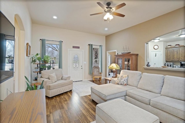 living area with baseboards, arched walkways, a ceiling fan, dark wood-style floors, and recessed lighting