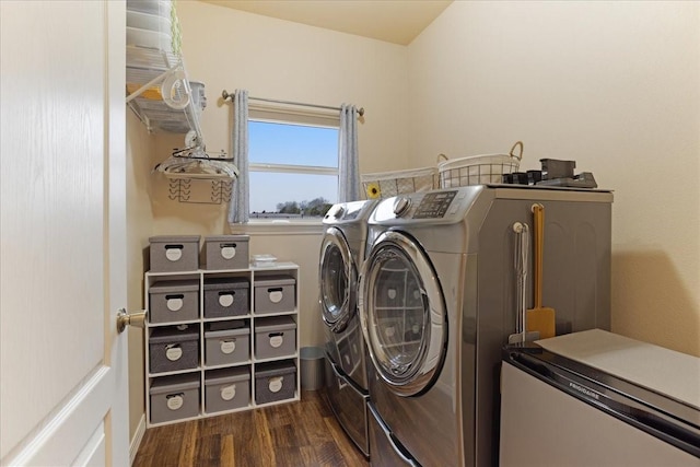 washroom featuring laundry area, dark wood finished floors, and washer and dryer