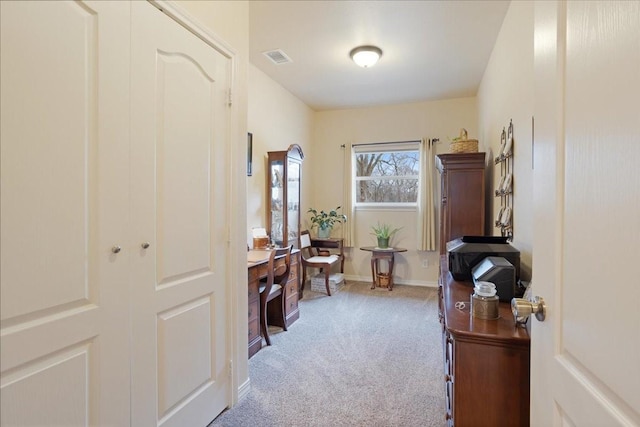 office area with carpet flooring, visible vents, and baseboards