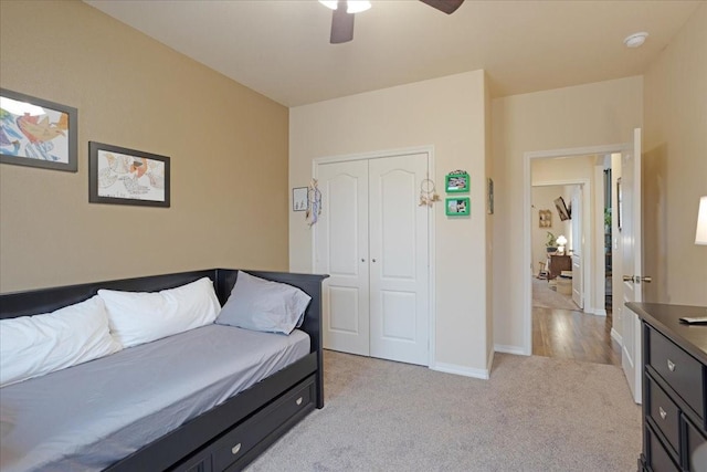 interior space with light carpet, ceiling fan, and baseboards