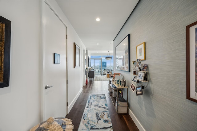 hallway featuring baseboards, dark wood-type flooring, and recessed lighting