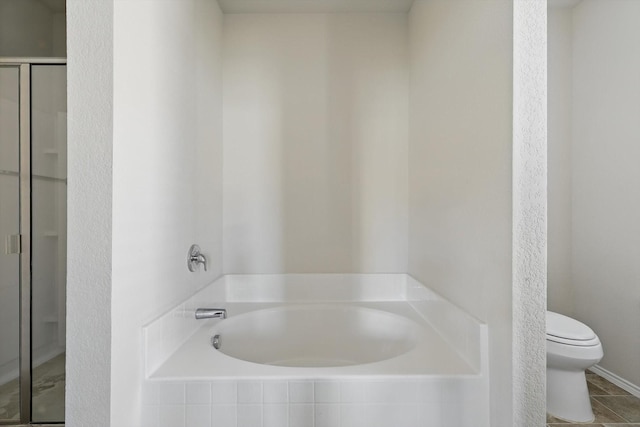 bathroom featuring toilet, a garden tub, tile patterned flooring, and a stall shower