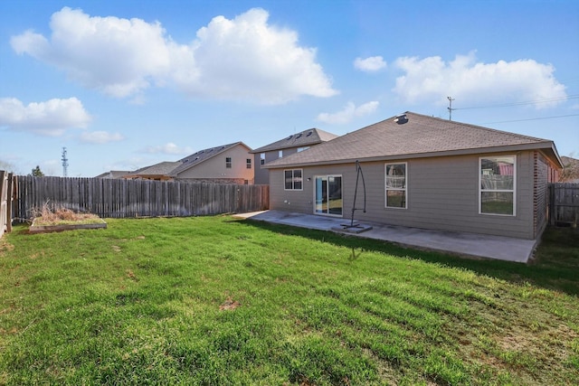 back of property featuring a fenced backyard, a lawn, and a patio