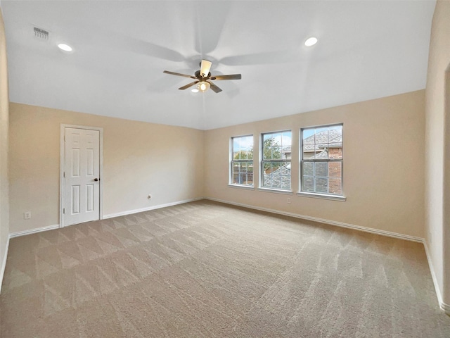 carpeted spare room featuring recessed lighting, visible vents, a ceiling fan, vaulted ceiling, and baseboards