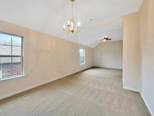 carpeted spare room featuring lofted ceiling, visible vents, baseboards, and ceiling fan with notable chandelier