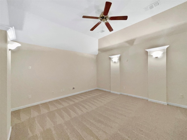 carpeted spare room featuring visible vents, ceiling fan, and baseboards