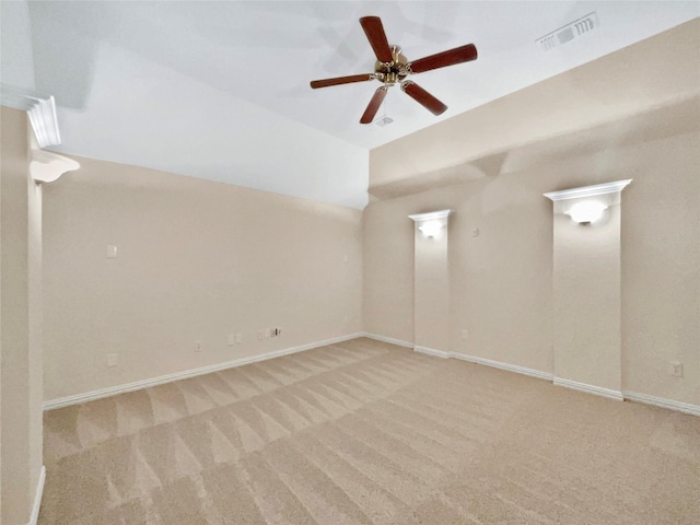 spare room with a ceiling fan, carpet, visible vents, and baseboards