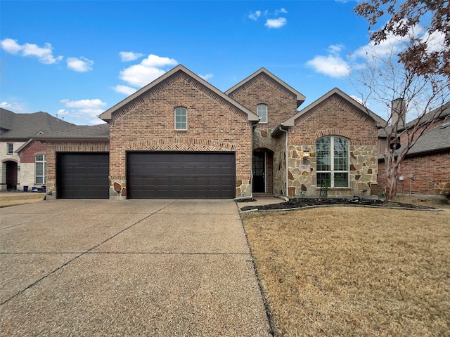 view of front of house with a garage, brick siding, concrete driveway, stone siding, and a front lawn