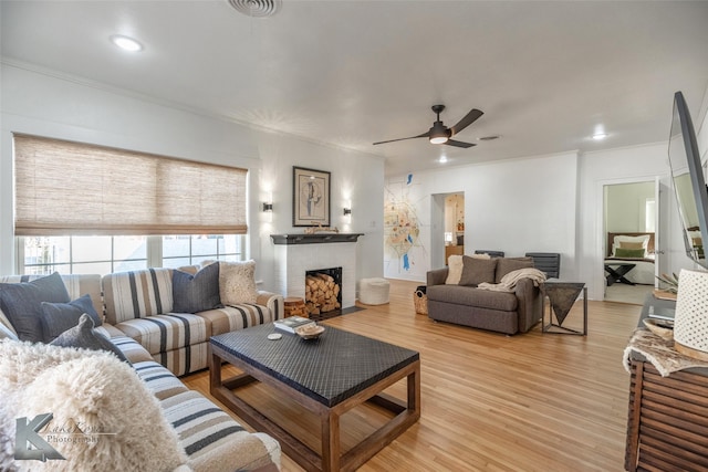 living room featuring visible vents, a ceiling fan, light wood-type flooring, a fireplace, and recessed lighting