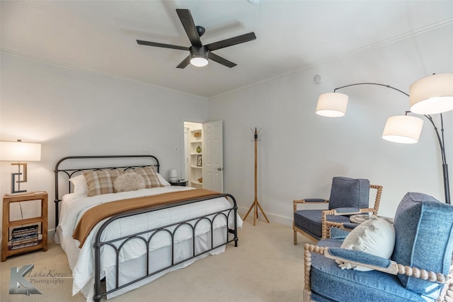 bedroom with ornamental molding, carpet, a ceiling fan, and baseboards