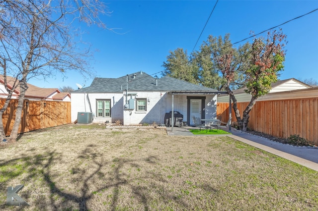 back of property featuring a yard, a patio, a fenced backyard, and central air condition unit