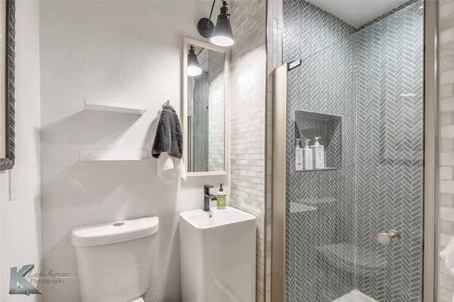 full bathroom with a stall shower and toilet