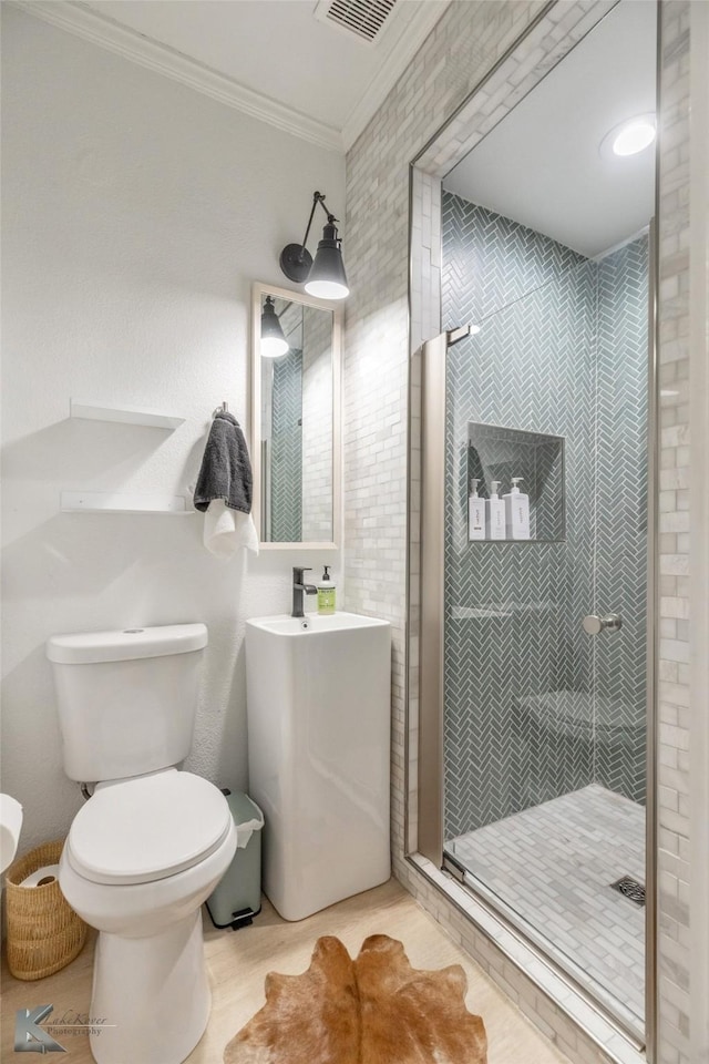 full bathroom with ornamental molding, visible vents, a shower stall, and toilet