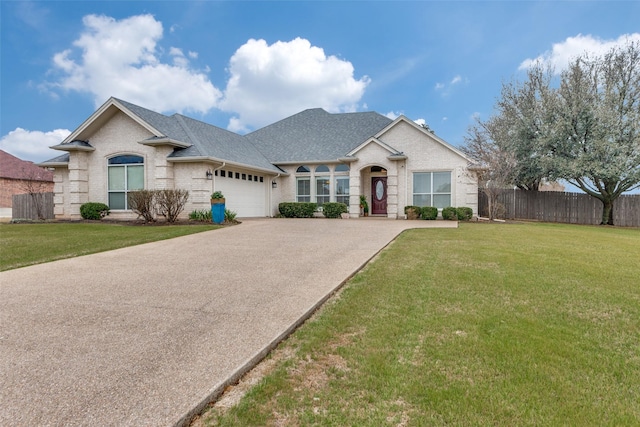 view of front of property featuring an attached garage, brick siding, fence, roof with shingles, and a front lawn