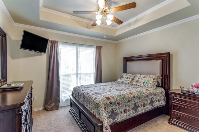 bedroom featuring ceiling fan, a tray ceiling, and light colored carpet