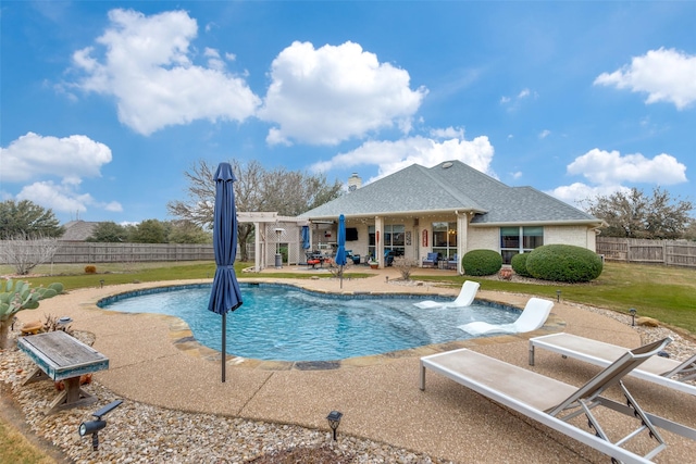 view of pool with a lawn, fence, a fenced in pool, and a patio