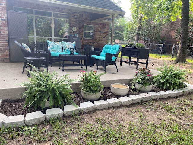 view of patio / terrace featuring outdoor lounge area and fence