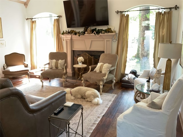 sitting room featuring dark wood-style flooring and a fireplace