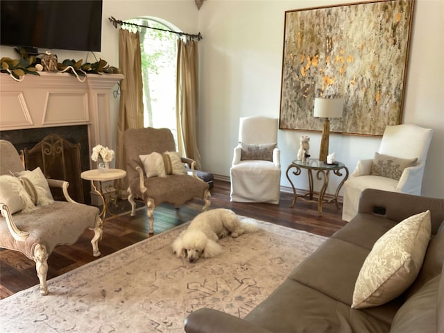 sitting room featuring a fireplace and wood finished floors