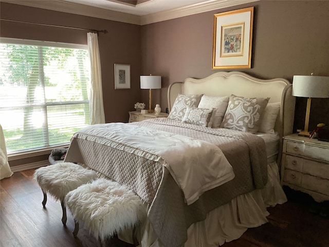 bedroom with multiple windows, ornamental molding, and wood finished floors