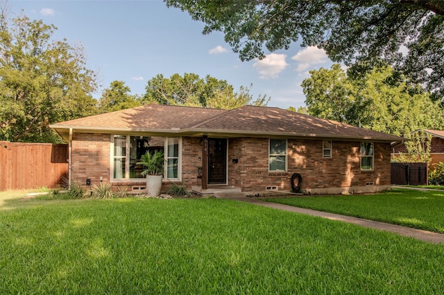 ranch-style house with crawl space, a front yard, fence, and brick siding