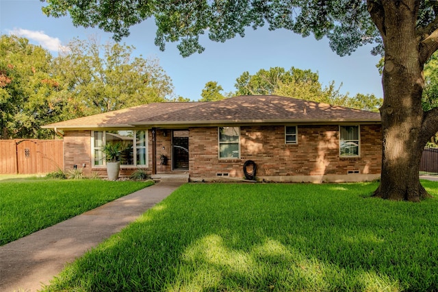 single story home featuring a gate, a front yard, fence, and brick siding