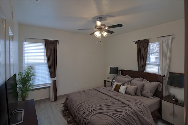 bedroom with a ceiling fan and wood finished floors