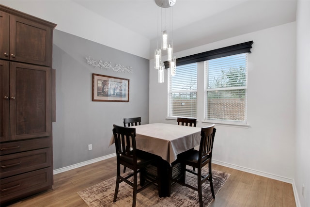 dining area featuring light wood finished floors and baseboards