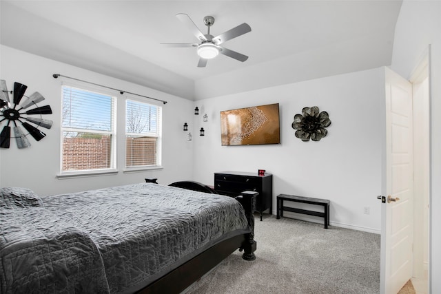 bedroom with lofted ceiling, ceiling fan, baseboards, and light colored carpet