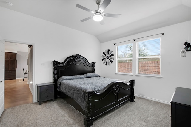 bedroom featuring a ceiling fan, lofted ceiling, light colored carpet, and baseboards