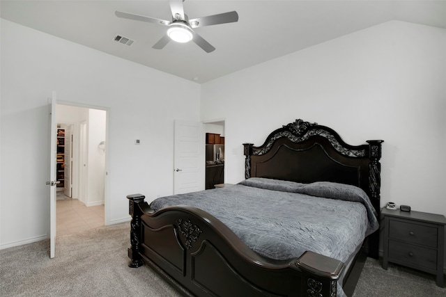 bedroom with stainless steel refrigerator with ice dispenser, light colored carpet, visible vents, vaulted ceiling, and ceiling fan