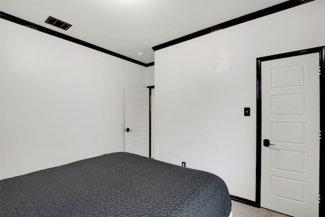 unfurnished bedroom featuring light carpet, visible vents, and crown molding