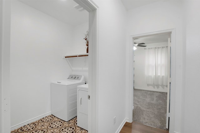 clothes washing area with laundry area, washer and dryer, and baseboards