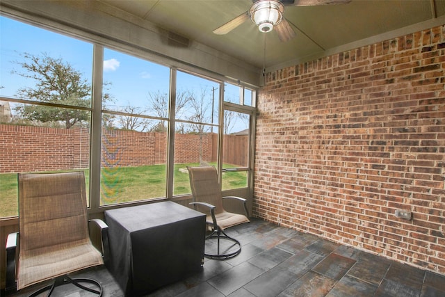 sunroom with plenty of natural light and a ceiling fan