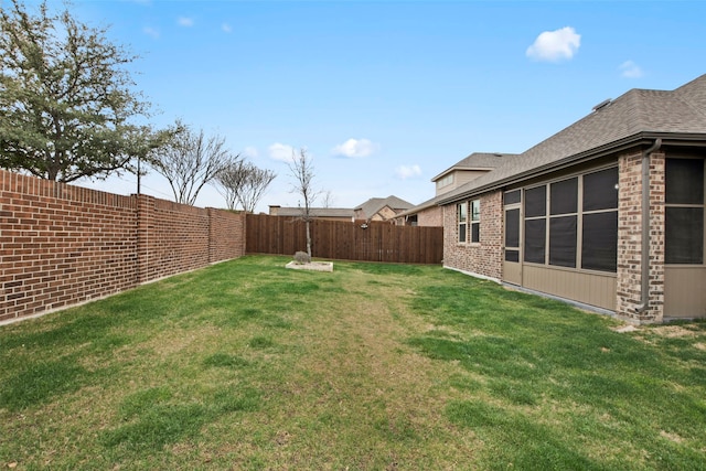 view of yard with a fenced backyard