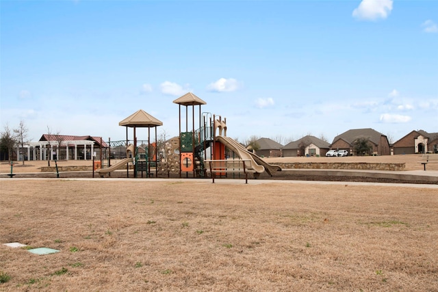 community jungle gym featuring a lawn