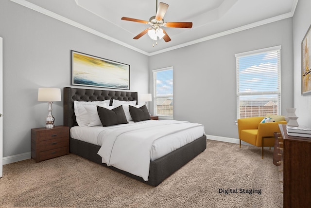 bedroom featuring carpet, baseboards, a tray ceiling, ceiling fan, and crown molding