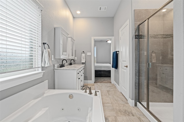 ensuite bathroom with vanity, visible vents, a stall shower, a whirlpool tub, and ensuite bathroom