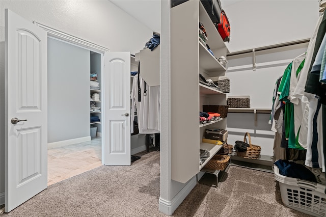 spacious closet with carpet flooring