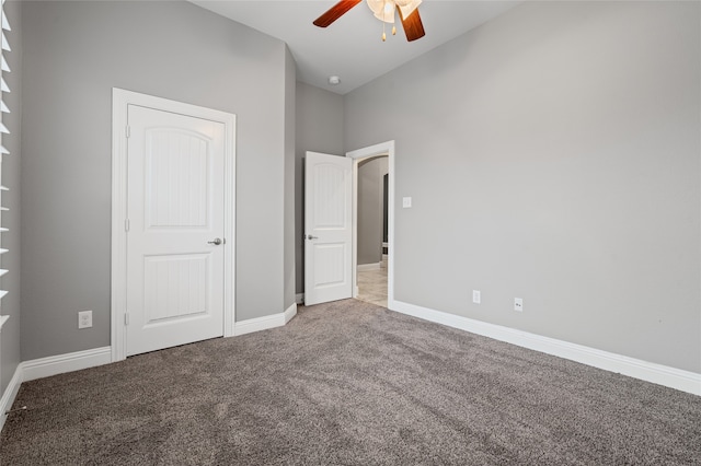 unfurnished bedroom with carpet, baseboards, and ceiling fan