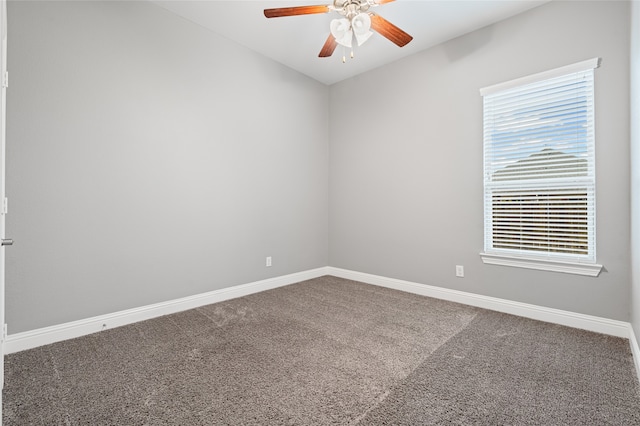 spare room featuring a ceiling fan, baseboards, and carpet floors