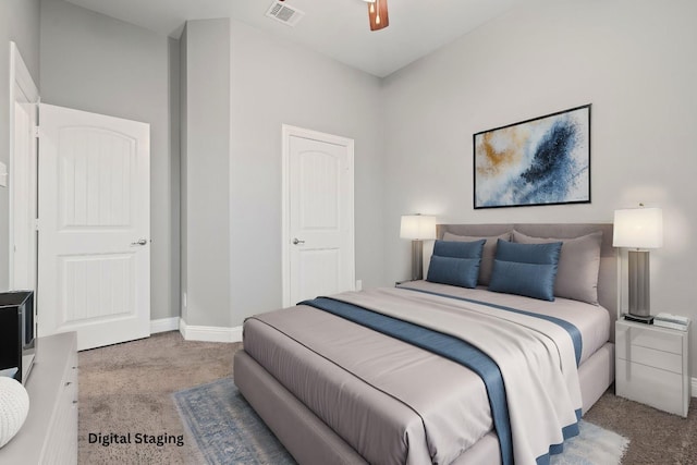 carpeted bedroom featuring visible vents, baseboards, and a ceiling fan