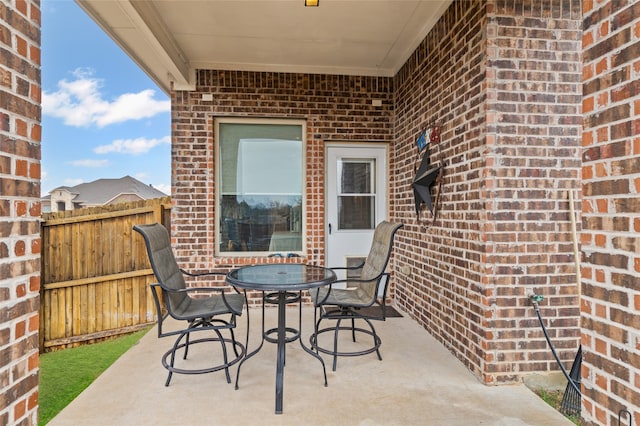 view of patio / terrace featuring outdoor dining area and fence