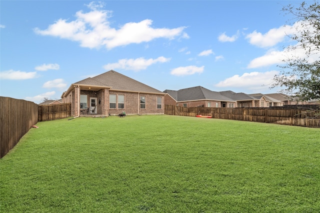 view of yard with a fenced backyard