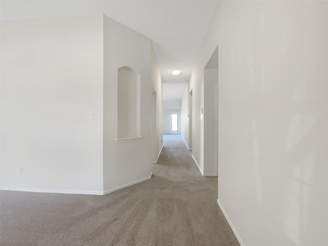 hall with carpet and baseboards