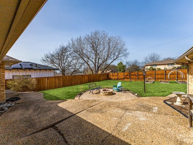 view of yard featuring a patio area, a fenced backyard, and an outdoor fire pit