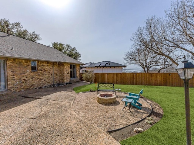 view of yard with fence private yard, an outdoor fire pit, and a patio