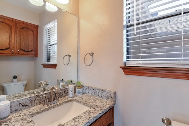 bathroom featuring toilet and vanity